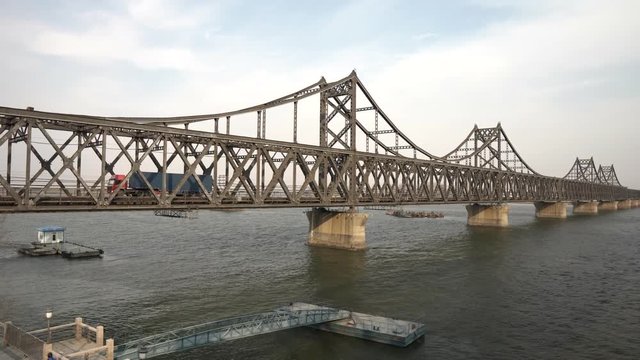 Truck drives over korean chinese friendship bridge from Sinuiju DPRK to Dandong China
