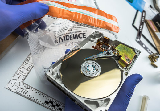Police expert examines hard drive looking for evidence and conceptual images