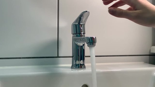 Earth day and water consumption. Saving clean water. Turn off the faucet and save water. Slowmotion of closing the water tap in bathroom. Cutting costs and preserving water.