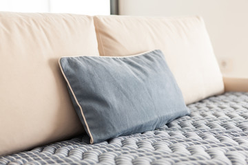 iviry sofa with blanket, cushion at the living room.