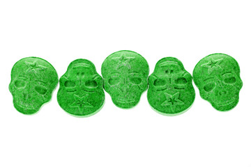 Green MDMA, Amphetamine, Army Skull, Ecstasy, XTC pills isolated on a white background.