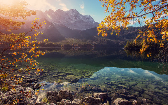 Impressive Autumn landscape The Eibsee Lake in front of the Zugspitze under sunlight. Amazing sunny day on the mountain lake. concept of an ideal resting place. Eibsee lake in Bavaria, Germany