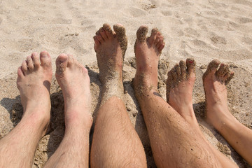 The feet relax on the beach.