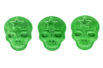 Green MDMA, Amphetamine, Army Skull, Ecstasy, XTC pills isolated on a white background.