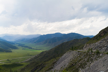 Fototapeta na wymiar Altai Mountain valley with white clouds. Summer time. Mountain car pass.