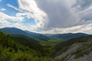 Altai Mountain valley with white clouds. Summer time. Mountain car pass.