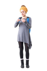 Cool stylish young hipster tourist woman rolling tobacco cigarettes carrying backpack. Full body isolated on white background. 