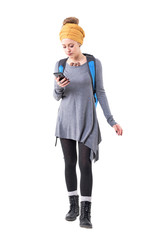 Cool stylish modern hipster woman with backpack searching for places on mobile phone application. Full body isolated on white background. 