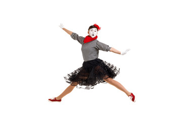 Full length portrait of mime woman artist jumping isolated on white background