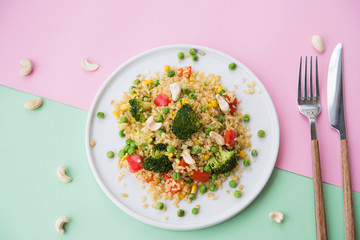 Vegetarian food. Bulgur with vegetables, broccoli, paprika and nuts. Healthy food.