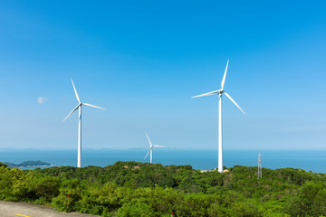Fototapeta premium Wind turbines in the mountains near the sea