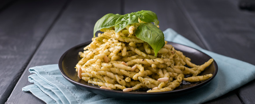 Traditional pasta trofie south of Italy with pesto and basil. Homemade meal for lunch. Copy space.