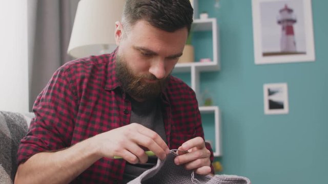 knitting by hands, on a soft gray background, tenderness, thick