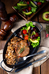 Pork steak with mushrooms and buckwheat groats and mango salad
