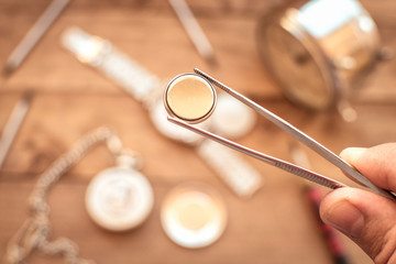 Watchmaker changing the stack of a clock.