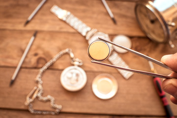 Watchmaker changing the stack of a clock.