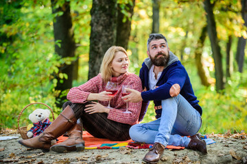 Celebrating anniversary. happy woman and bearded man drink wine. cheers. Red wine in fall weather. love date romance. Spring mood. Family picnic. Happy couple. couple in love relax in autumn forest