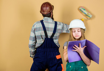 Family remodeling house. Little fathers helper. Father bearded man and daughter hard hat helmet uniform renovating home. Home improvement activity. Kid girl planning renovation. Child renovation room