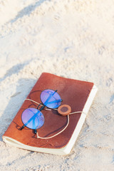 Traveler's storybook Placed on the beach on a sunny day.it look like vintage books in pirate story