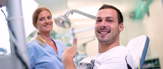 Young smiling man at dentist's office.
