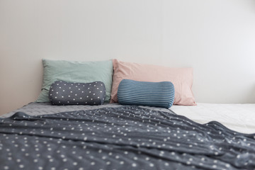 bedroom with tint color pillow and blanket.