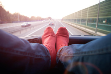 feet of relaxing tourist on a bus window during bus trip