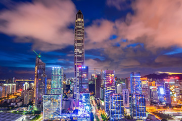 Tall buildings and traffic roads in downtown shenzhen at night.