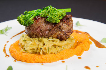 Beef sirloin with sweet potato mousse, curry sauerkraut and fresh thyme sauce