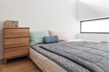 bedroom with tint color pillow and blanket.