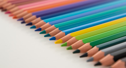 Closeup of coloured pencils lined up in a row