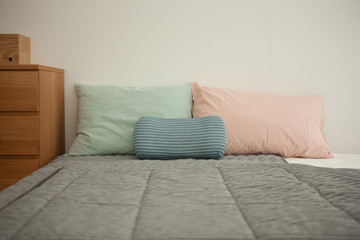 bedroom with tint color pillow and blanket.