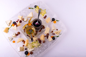 Cheese plate. Top view. Tasty cheese starter on white background.