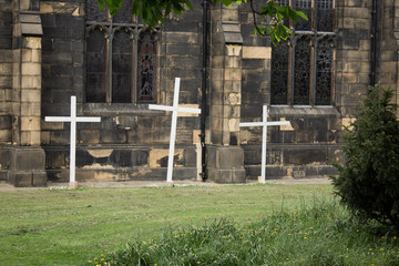 A church in Yorkshire portrays the Easter Message with three simple white crosses erected outside...