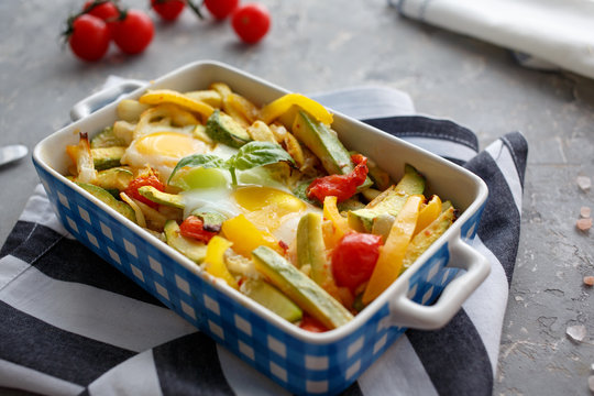 Baked vegetables with egg. Zucchini and pepper. Top view.