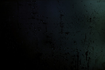drops and splashes of water on a black matte background, texture for the designer