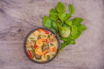 Fototapeta na wymiar Thai food chicken green curry on dark wooden background. top view
