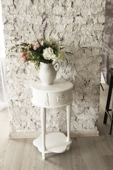 Modern Hallway White mini Closet Near white brick Wall with white vase and flowers