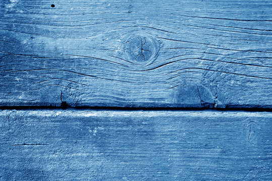 Weathered wooden painted wall in navy blue color.