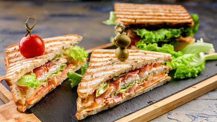 Classic toast sandwich with smoked beef, cheese, tomatoes and lettuce. Traditional breakfast or lunch