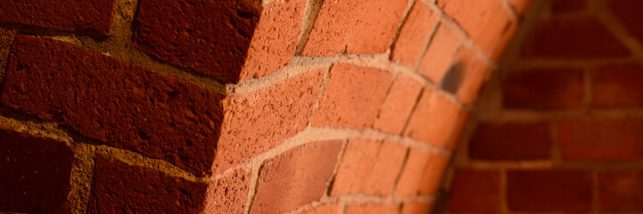 Old red brick wall with an arc background