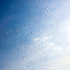 Soap bubbles fly in the blue sky