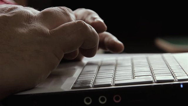 Male Fingers Typing On A Laptop Computer. 