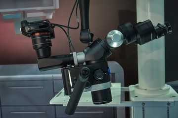 Optical system with a microscope and a movie camera to study various objects in dentistry