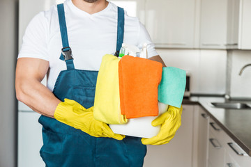 Cleaning service with professional equipment during work. professional kitchenette cleaning, sofa dry cleaning, window and floor washing. man and women in uniform, overalls and rubber gloves