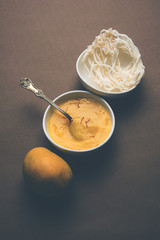 Aam Ras or Alphonso mango pulp with kurdai which is a fried dish made using wheat/gehu. selective focus