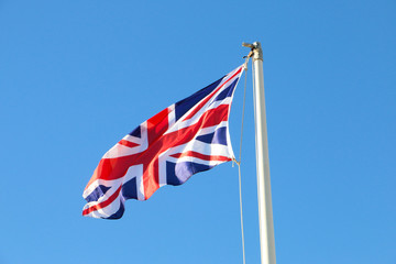 British flag flyng, on a beautiful blue sky day 