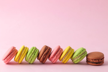 Macarons. french multicolored macaroons cakes. small french sweet cake on bright pink background. Dessert. Sweets.