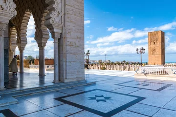 Poster RABAT, MOROCCO - MARCH 20, 2018: Beautiful Mausoleum of Mohammed V and square with Hassan tower in Rabat on sunny day. March 20, 2018 in Rabat, Morocco © olenatur