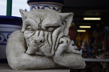 Pensive ceramic figure of a dog.