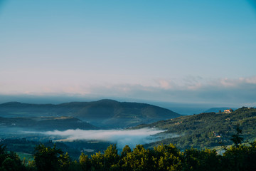 Fototapeta na wymiar Beautiful foggy landscape in Tuscany, Italy.